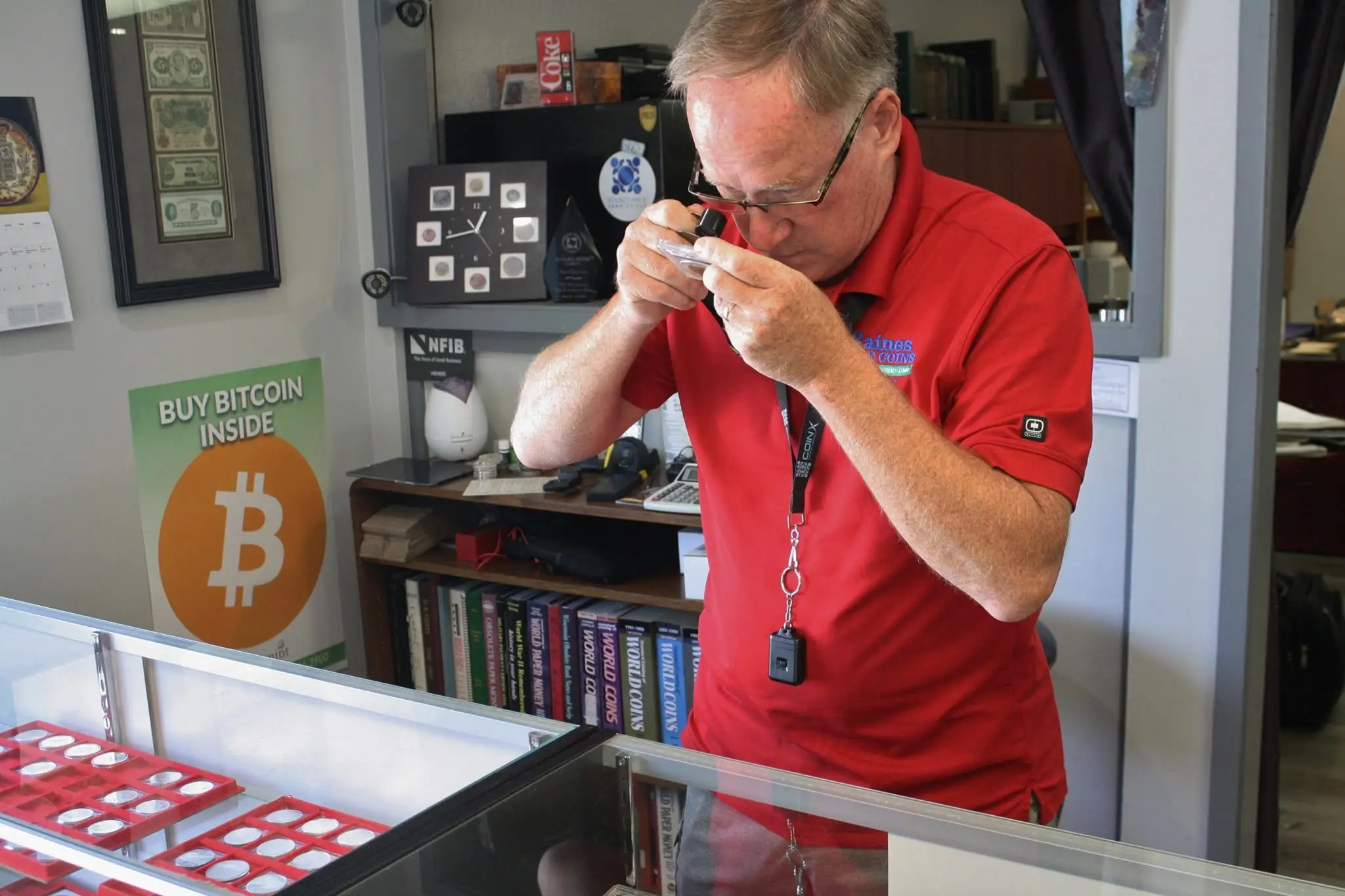 Numismatist examining coin